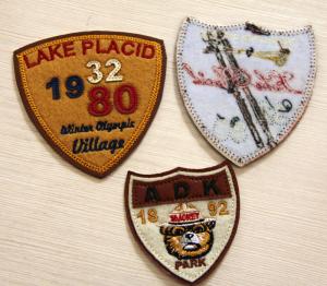 China PU Leather Embroidered Custom Sew On Patches RPET Fabric Plain Back. factory