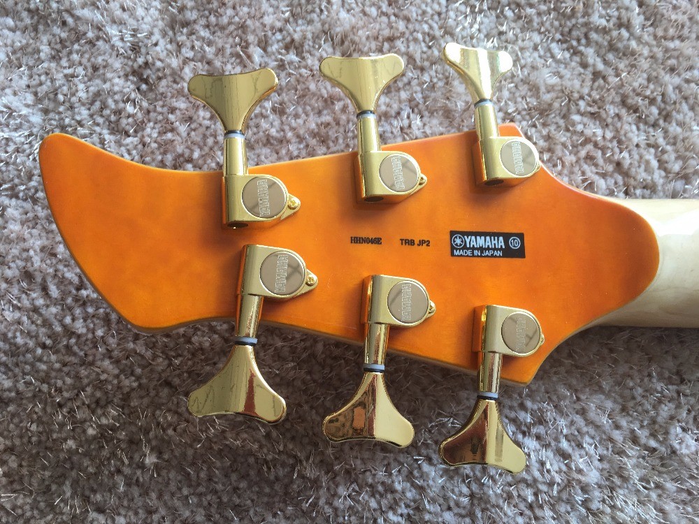 6 string bass guitar JP2 yellow quilted maple body back and front Active pickups Golden bridges and tuner Alder with ebo