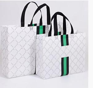 China Logo Printed Gilding Striped Apparel Paper Bag Packaging For Clothes factory