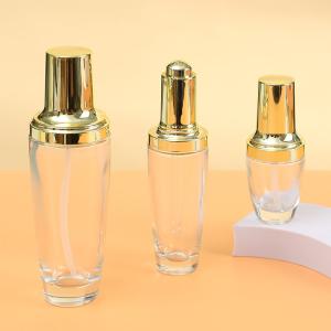 China Printing Handling Decoration Firing 100ml Glass Spray Bottle for Body Oil Economical Custom Logo Design Golden Glass Bottles factory