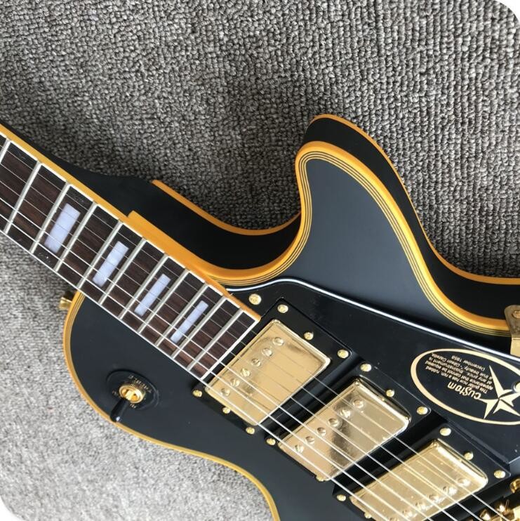 Grand LP electric guitar black with bigsby, yellow body binding, 3 pickups, gold hardwares