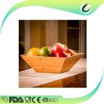 big bamboo salad and fruit bowl with hand servers