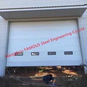 China Full Vertical Lift Door Motorized Industrial Garage Doors With Transparent Windows And Pedestrian Access factory