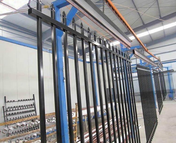 Black welded steel fence panels are hanging in the storehouse.