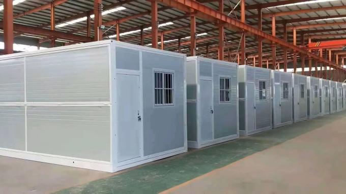 Cost-effective transport of multiple folded prefab houses in standard shipping configuration