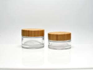 China Sustainable classic 1OZ 1.7OZ Clear or Frosted Glass Cosmetic Jar With Real Bamboo Cap Lid for skincare Face Cream factory