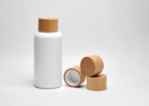 China Sustainable 100ml Boston Round Opal White Glass Lotion Bottles With Wooden Screw Cap, Primary Cosmeceutical Packaging factory