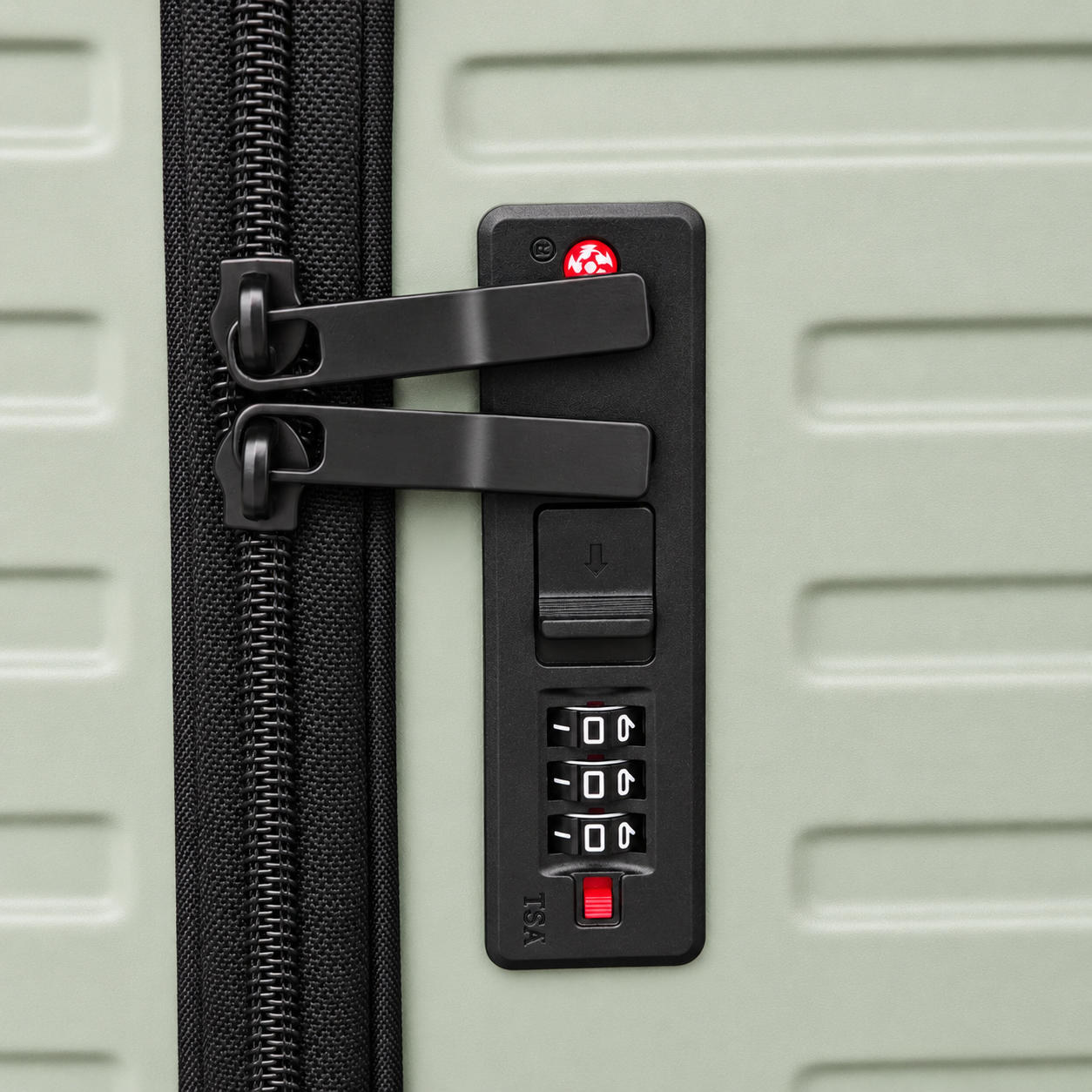 Close-up of built-in TSA combination lock beside the suitcase zipper