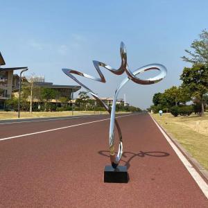China Decorative Stainless Steel Polished Ribbon Sculpture With Black Stone Base factory