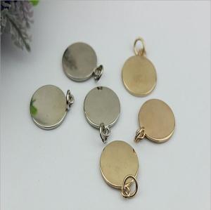China Handbag hardware metal round shape flat logo label tag plate with light gold factory