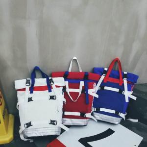 China Contrast color roll mouth portable travel backpack European and American large-capacity couple backpack factory